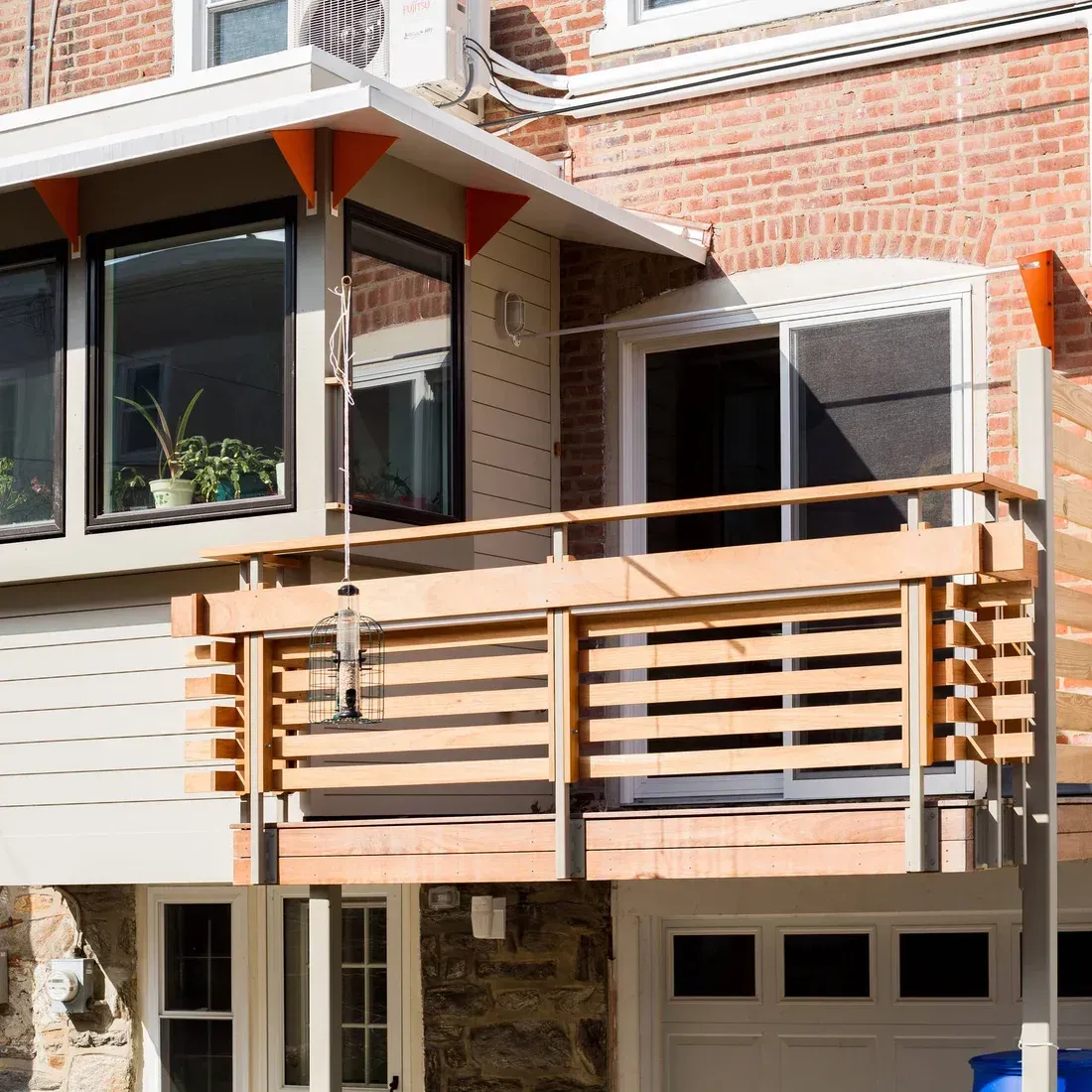 A brick building with a balcony and a sliding glass door